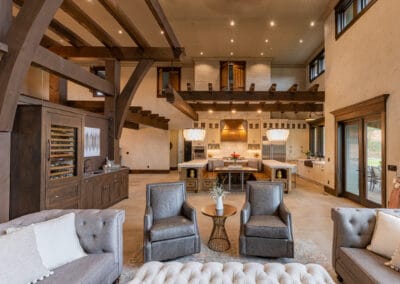 This hybrid timber frame home featured brick & timbers on the exterior. The inside of this home is most unique. With 25 foot high ceilings in the Great Room, the timbers create a ceiling feel without enclosing the space. More brick is also featured on the fireplace. The timbers have a darker stain that contrasts against the white walls. Most noteworthy is the door selection, which are all selected from older buildings. Each door was chosen before the floor plans were complete. Even doors from a rodeo were incorporated into the main area of this home. The timber package is a hybrid timber frame kit explicitly designed for this floor plan. Enjoy the distinctive design and look of this gorgeous Mediterranean Hybrid Timber Frame Home.