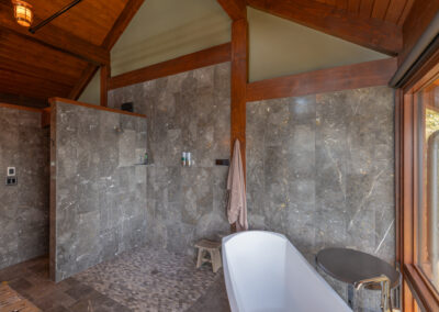 master bathroom with tub and post and beam